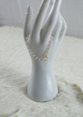 Gouden armband met witte parels en hartje