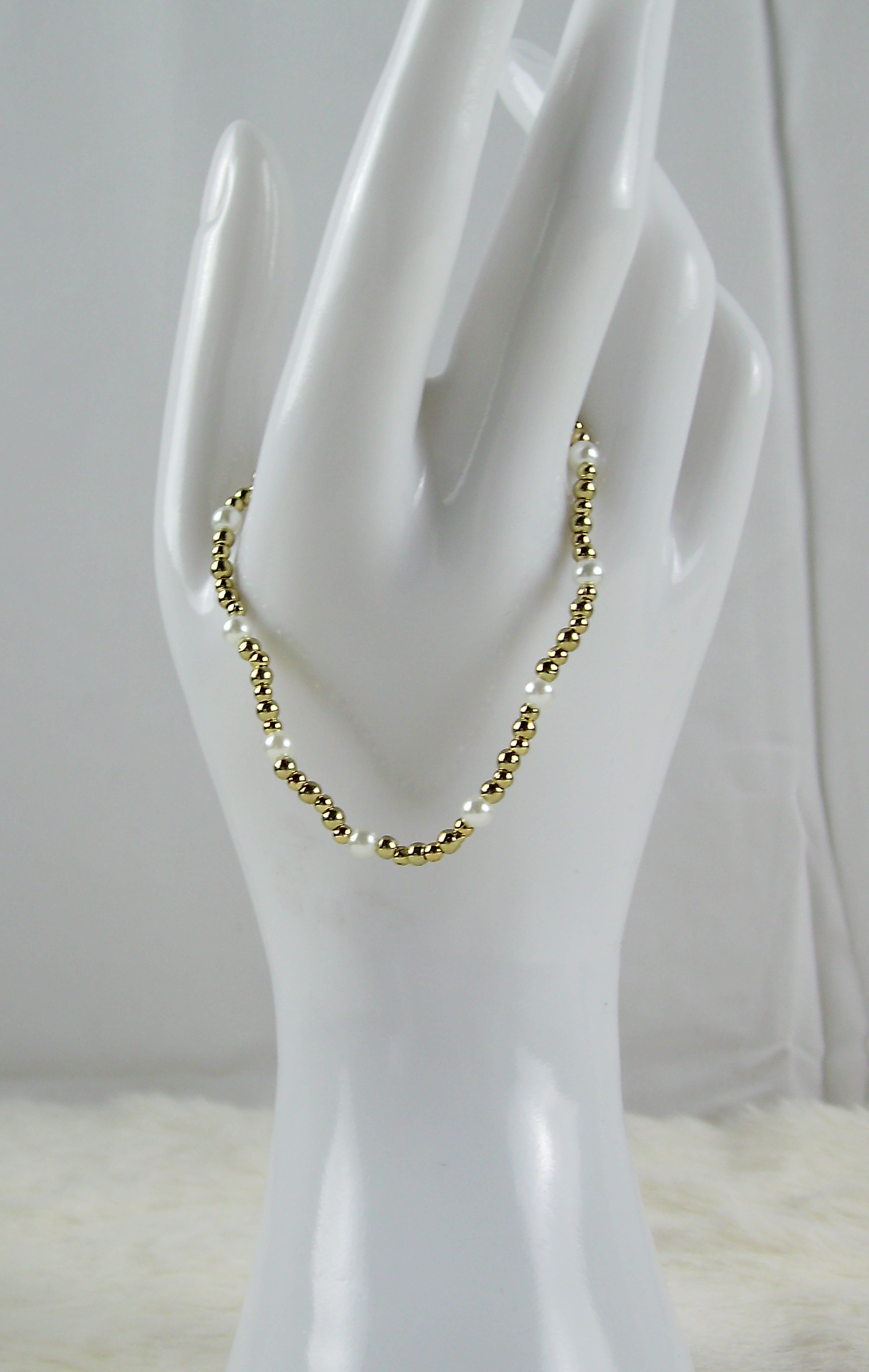 Gouden kralen armband met pareltjes