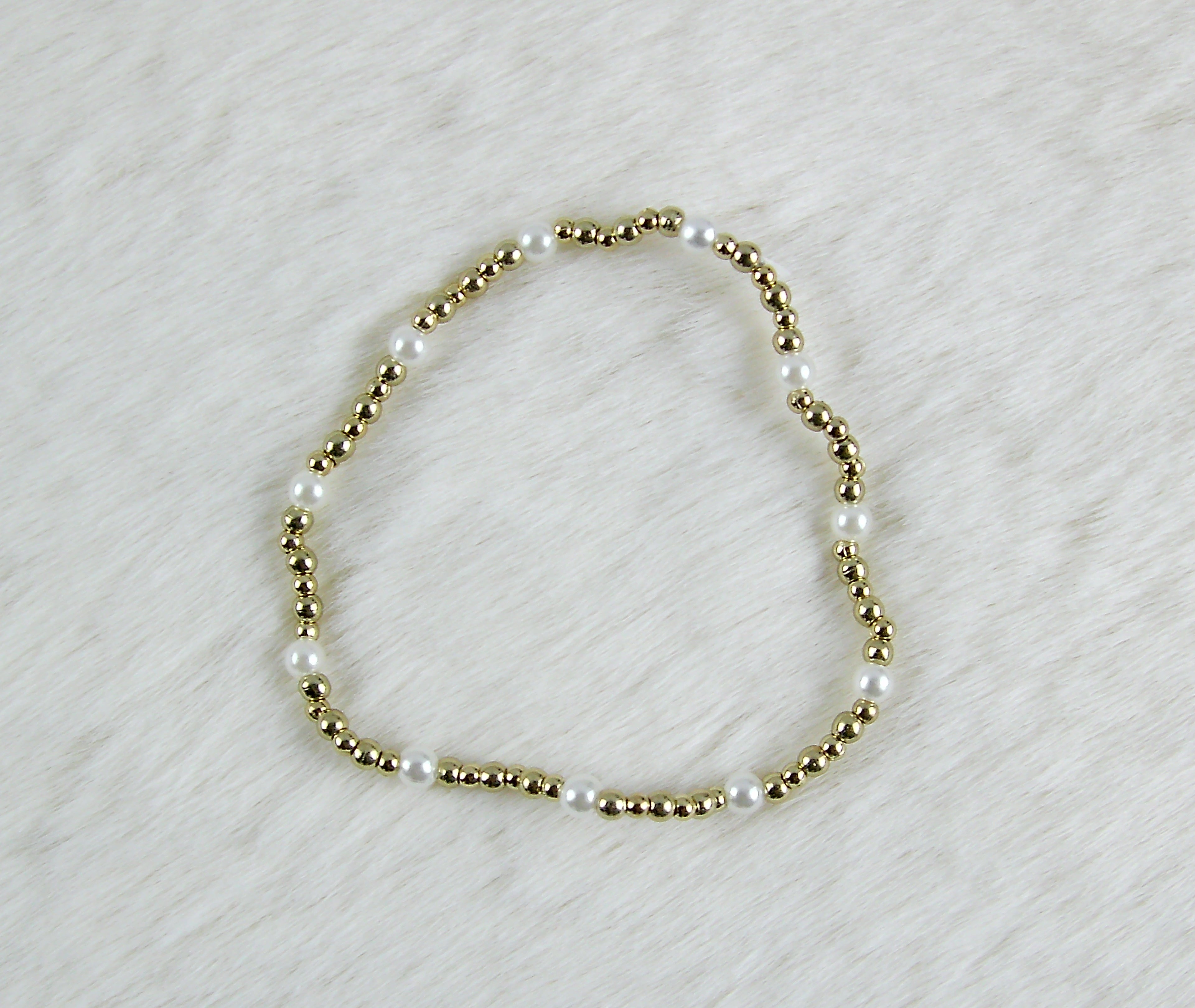 Gouden kralen armband met pareltjes