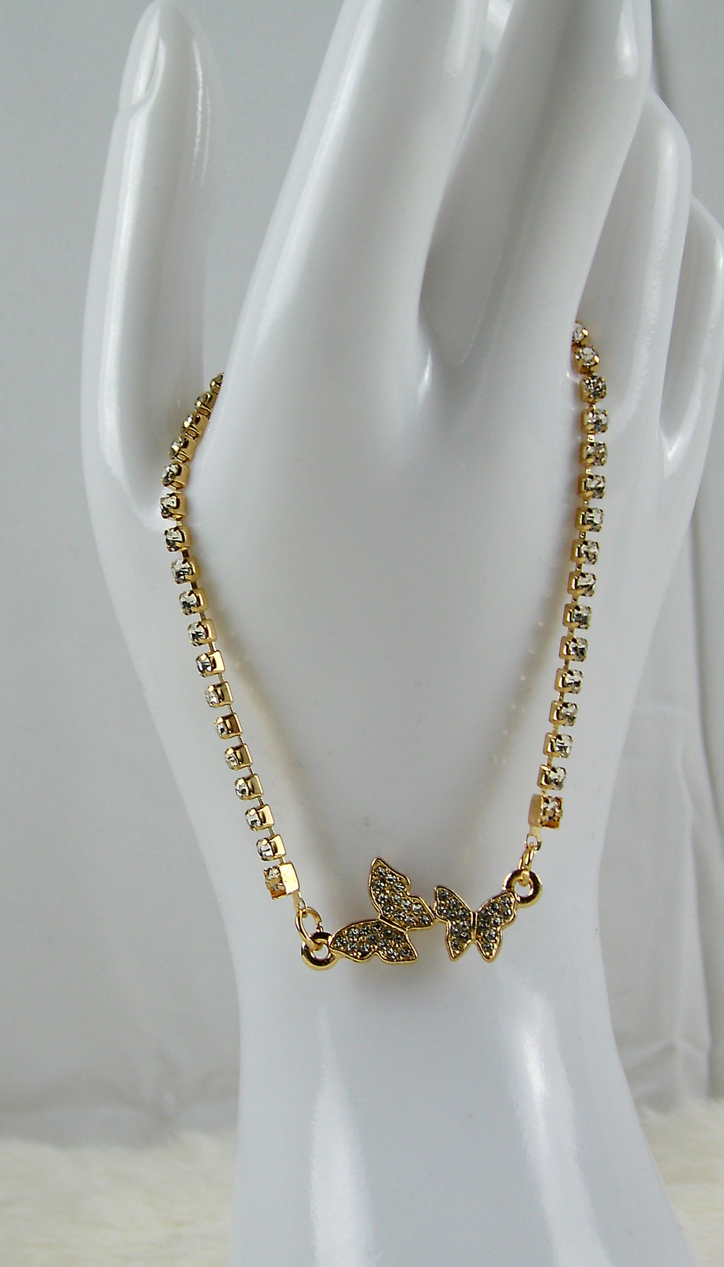 Gouden armband met 2 vlindertjes en diamantjes