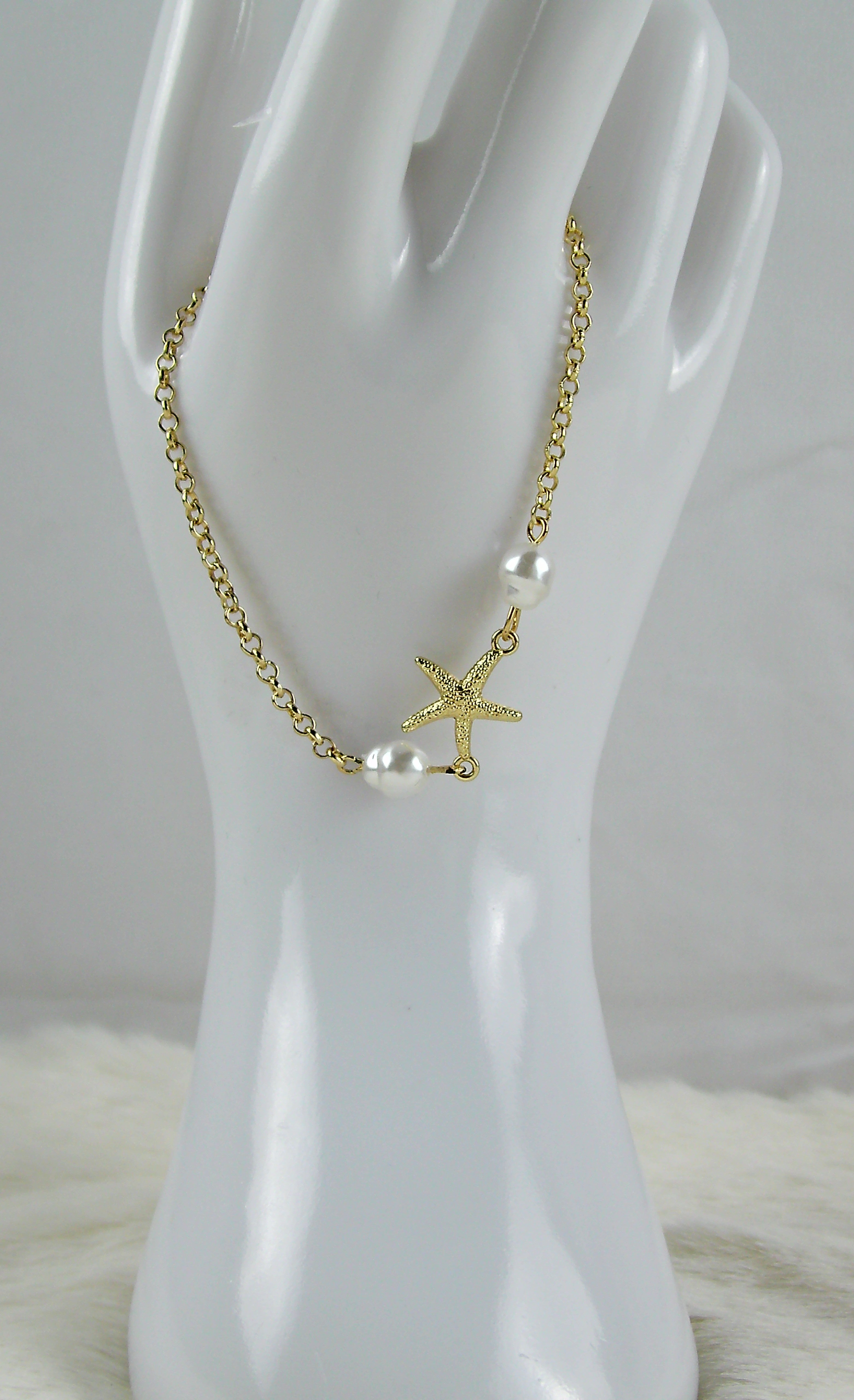 Gouden zee armbanden met ster en pareltjes