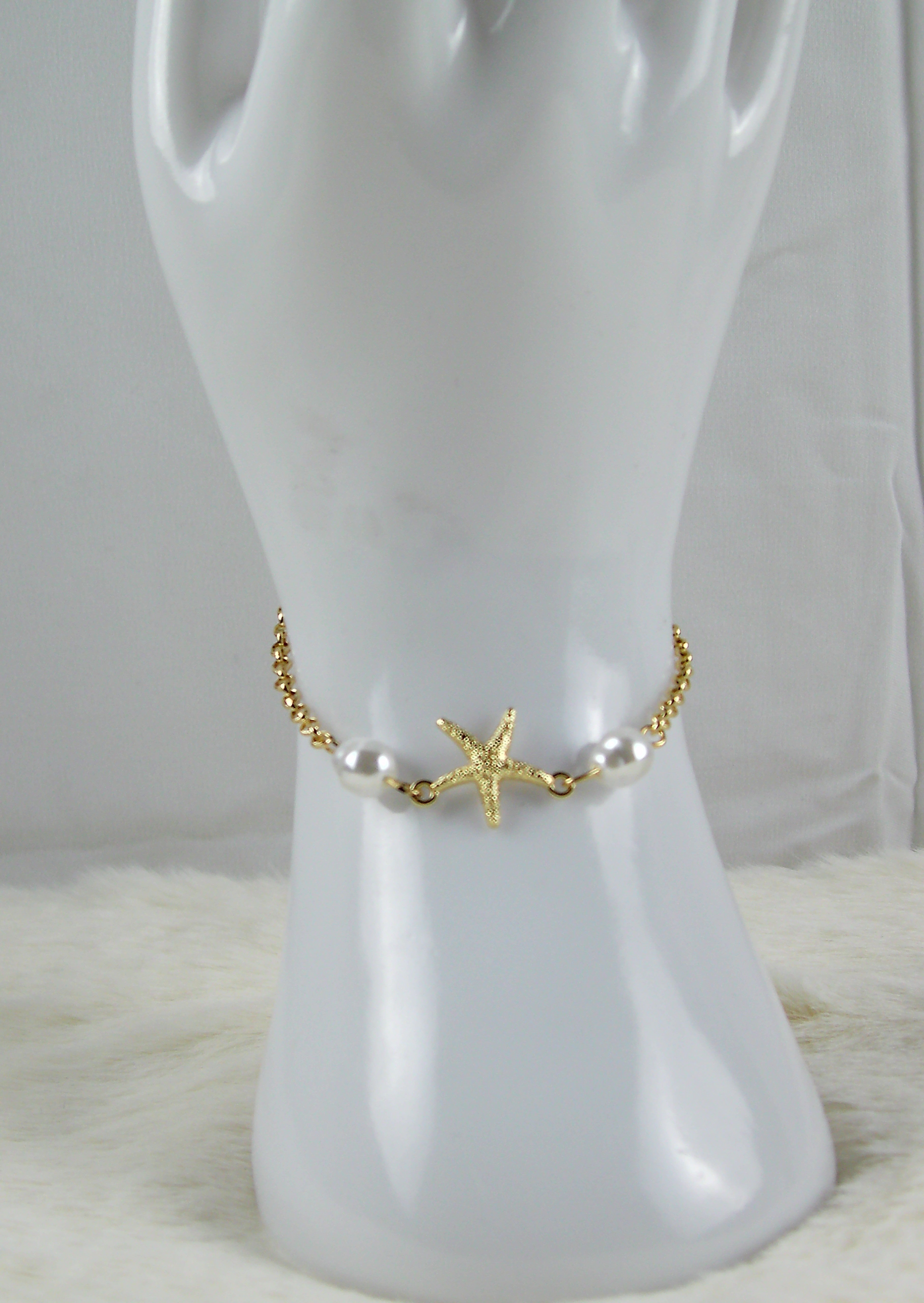 Gouden zee armbanden met ster en pareltjes