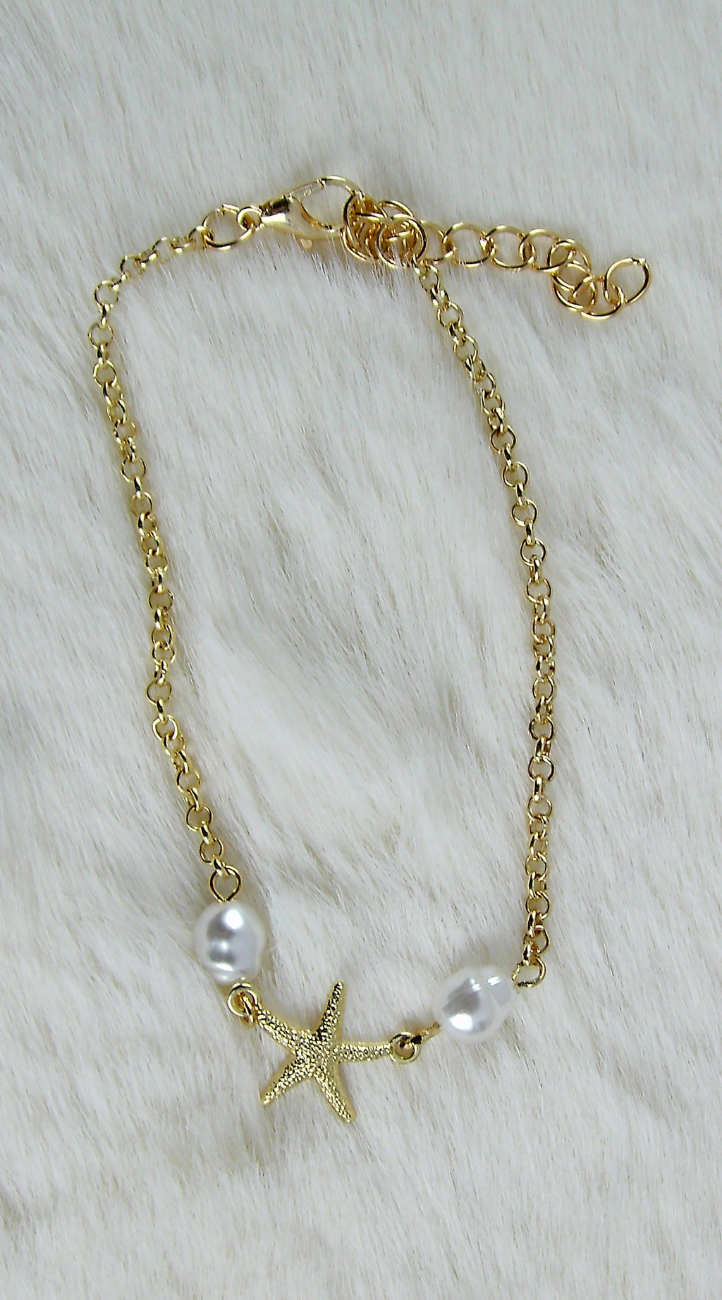 Gouden zee armbanden met ster en pareltjes