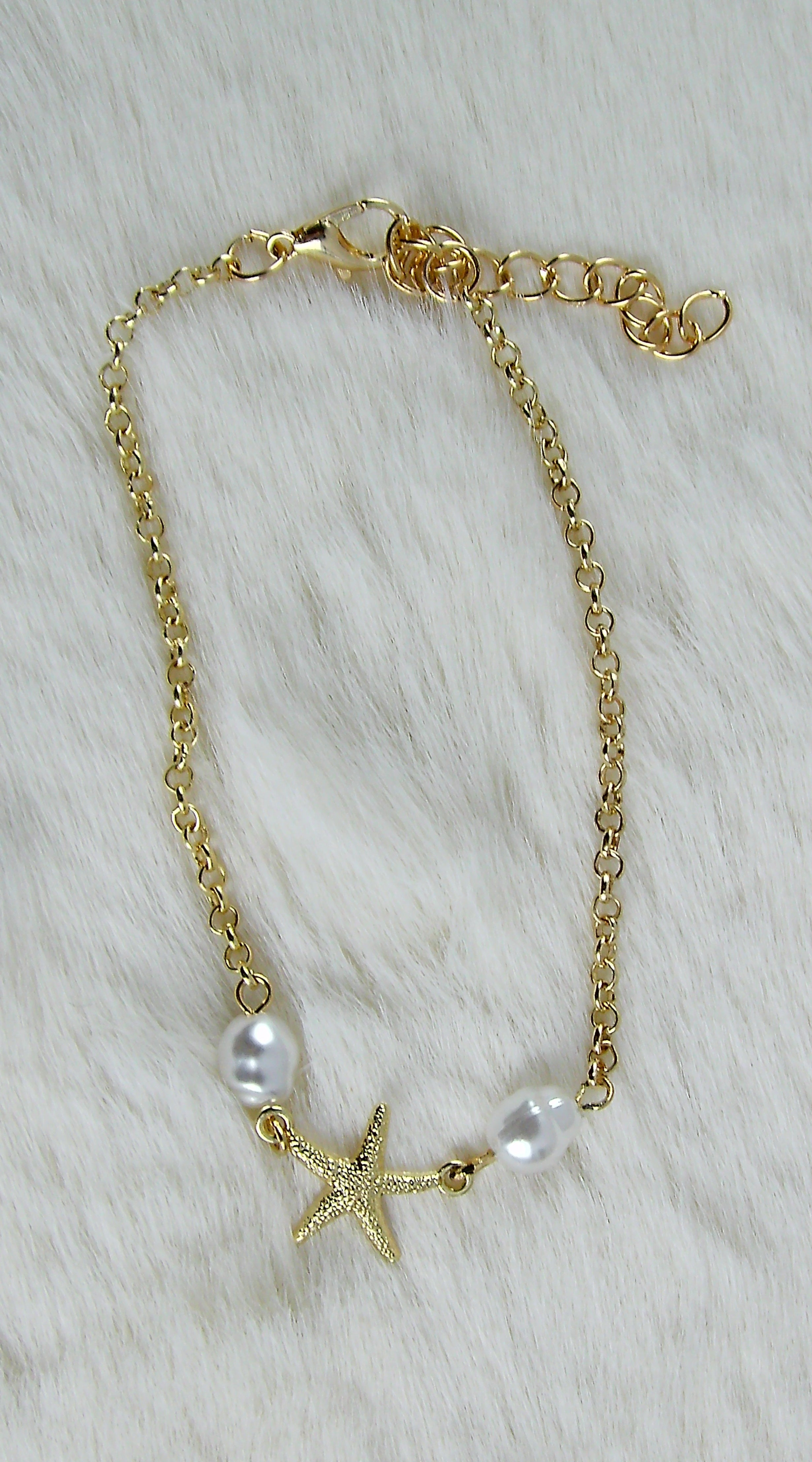 Gouden zee armbanden met ster en pareltjes